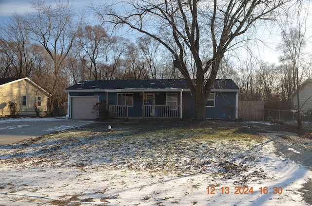 ranch-style house featuring a garage and covered porch