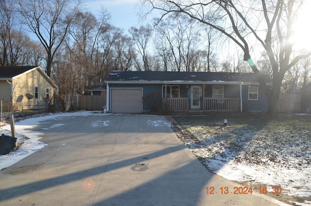 ranch-style home with a garage and a porch