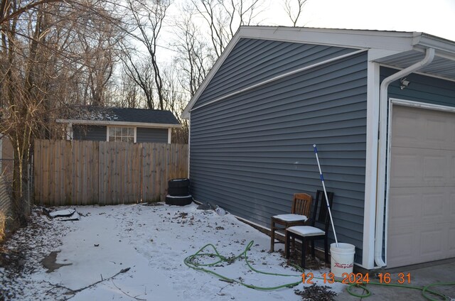 view of snow covered exterior featuring a garage