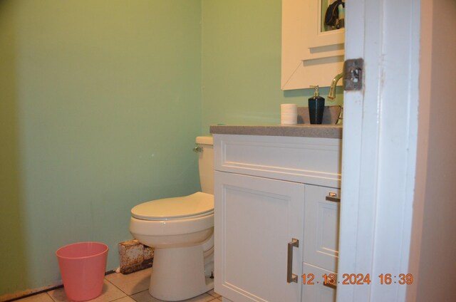 bathroom featuring vanity, tile patterned floors, and toilet