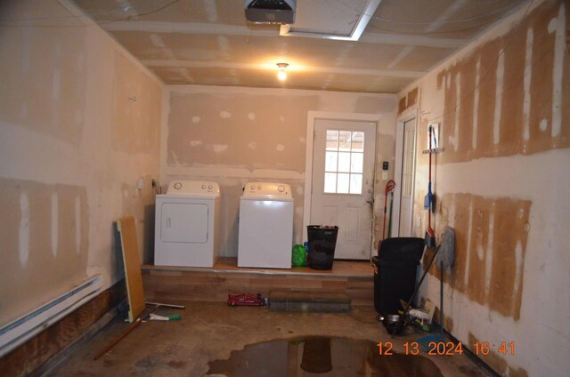 laundry room featuring independent washer and dryer and a baseboard heating unit