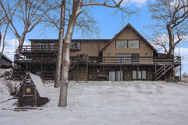 snow covered property featuring a wooden deck