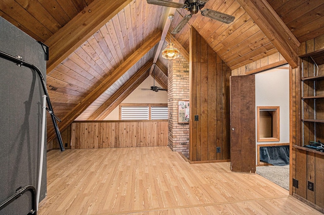 bonus room with vaulted ceiling with beams, wood walls, and light wood-type flooring