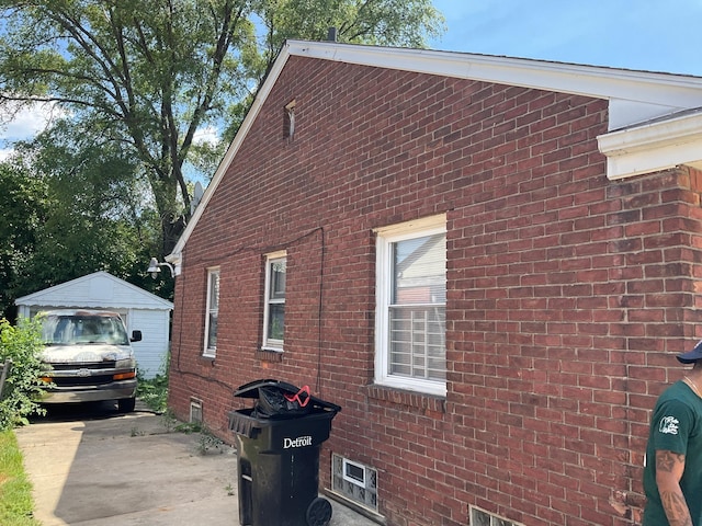 view of property exterior with a garage and an outdoor structure