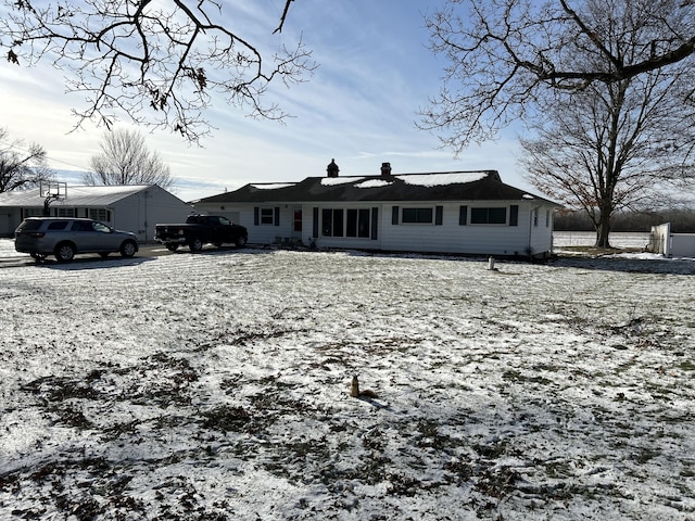 view of snow covered back of property