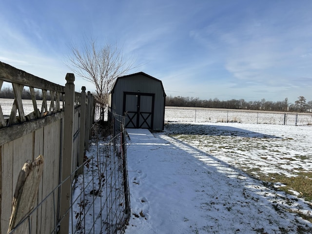 snowy yard with a shed