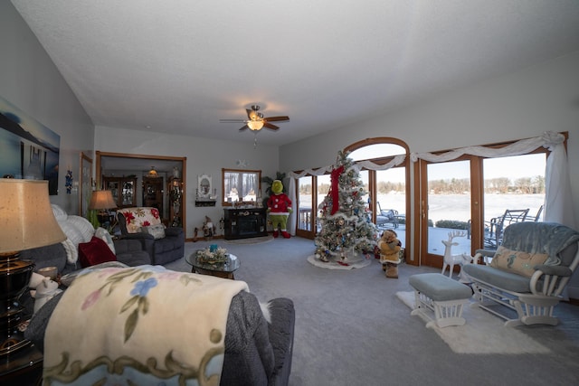 carpeted living room with plenty of natural light, ceiling fan, and a textured ceiling