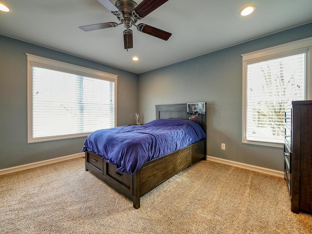 bedroom featuring light colored carpet and ceiling fan