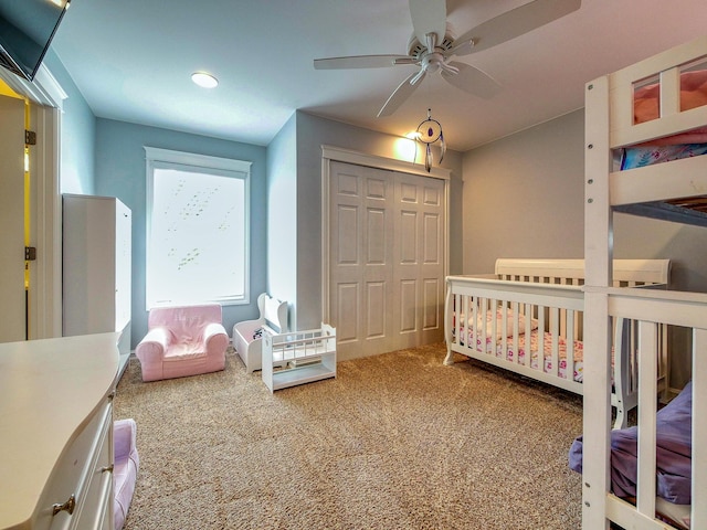 bedroom featuring carpet flooring, ceiling fan, and a closet