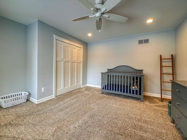 unfurnished bedroom featuring carpet flooring, ceiling fan, and a closet