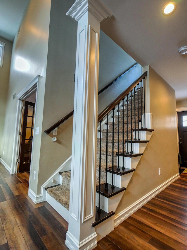 staircase with wood-type flooring