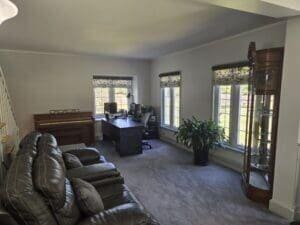 living room with carpet floors and crown molding