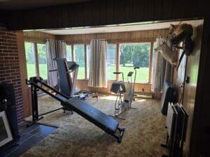 exercise area featuring dark carpet and a healthy amount of sunlight