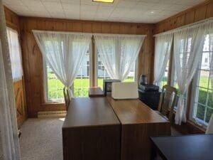 unfurnished office with wooden walls and carpet