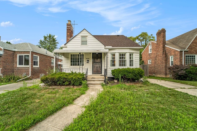 bungalow-style home with a porch and a front yard