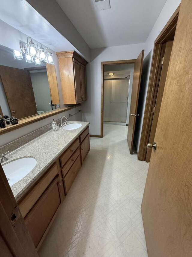 bathroom featuring vanity, toilet, and a shower