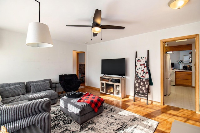 living room featuring hardwood / wood-style flooring and ceiling fan