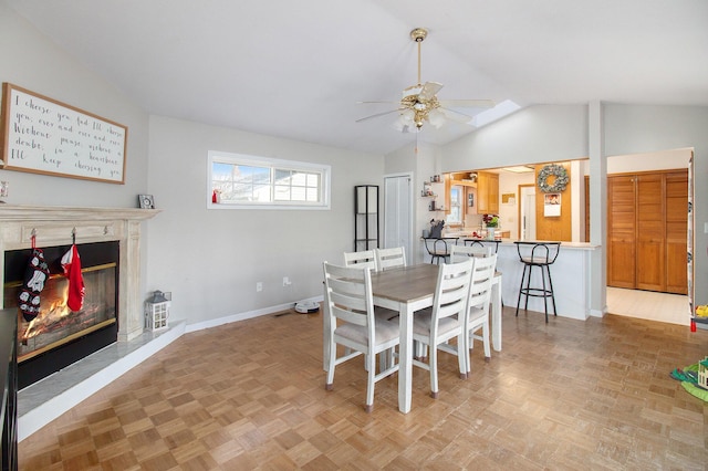 dining area featuring light parquet floors, vaulted ceiling, and ceiling fan