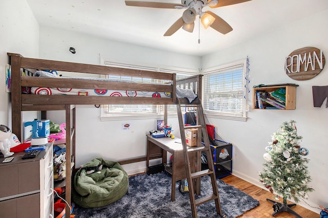 bedroom with ceiling fan and wood-type flooring