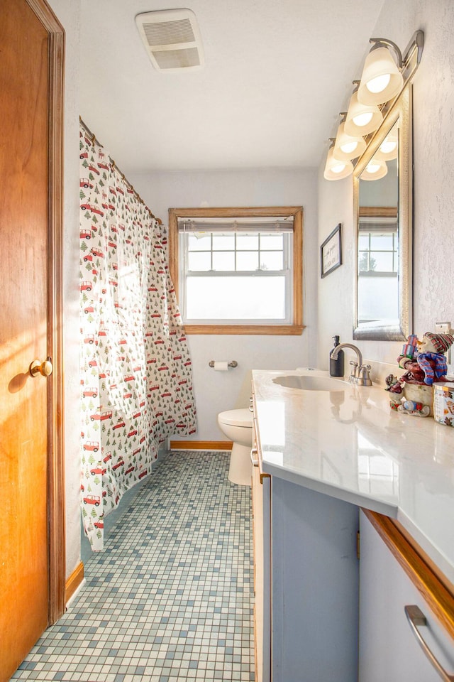 bathroom with vanity and toilet