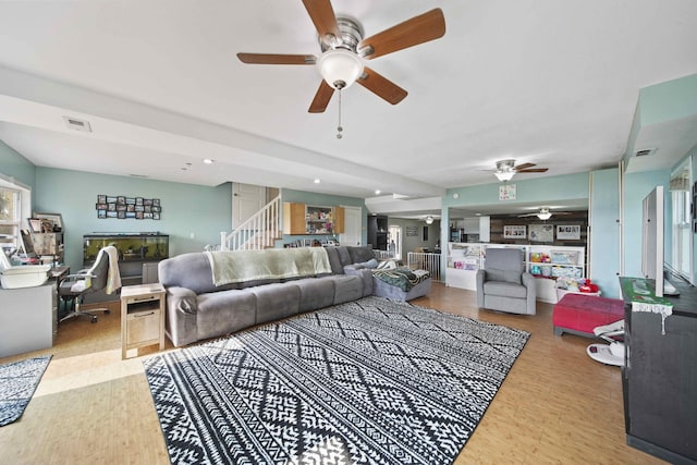 living room with ceiling fan and light hardwood / wood-style floors