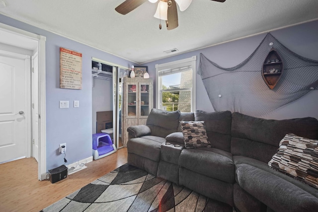 living room featuring light wood-type flooring and ceiling fan