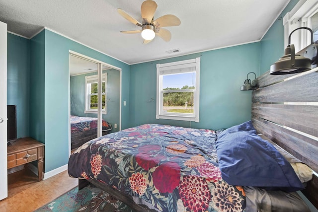 bedroom featuring wood-type flooring, a textured ceiling, a closet, and ceiling fan