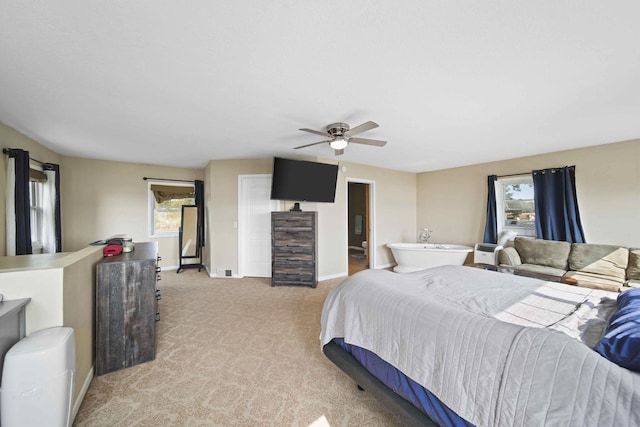 bedroom featuring multiple windows, light carpet, and ceiling fan