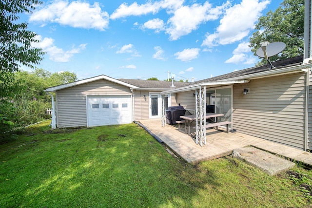 back of property with a garage and a lawn