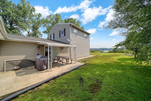 back of house featuring a yard and a deck