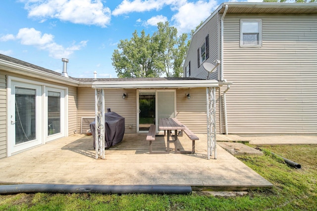 back of house featuring a wooden deck