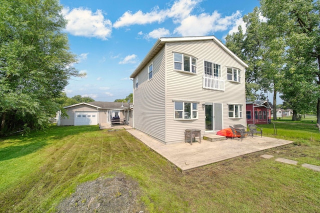 rear view of property with a patio area, a yard, and an outbuilding