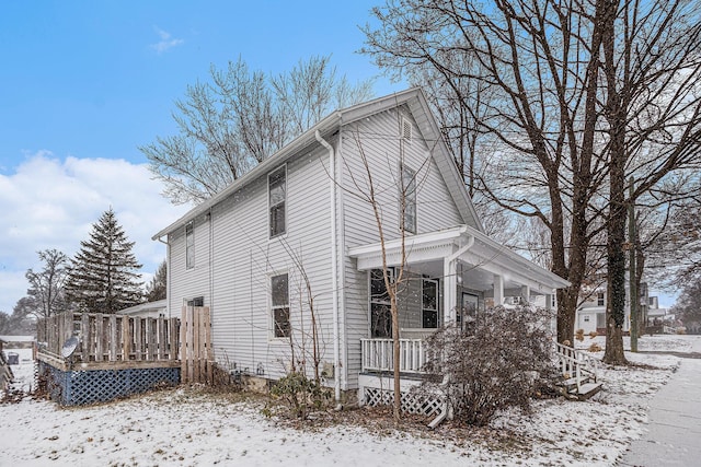 view of snow covered exterior with a porch