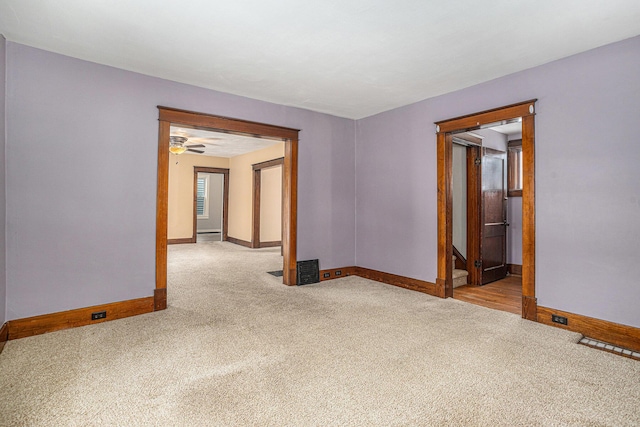 carpeted empty room featuring ceiling fan