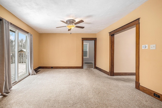 carpeted spare room with a textured ceiling and ceiling fan