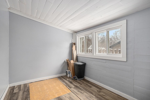 unfurnished room featuring wood-type flooring, crown molding, and wood ceiling