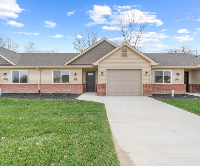 ranch-style house featuring a garage and a front lawn