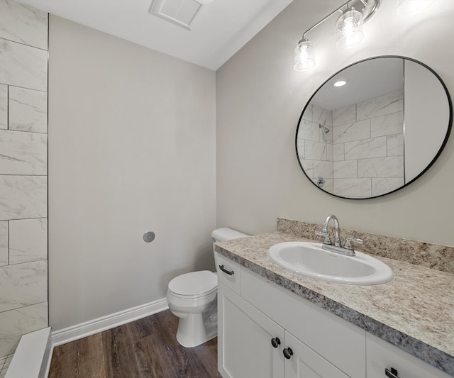 bathroom featuring hardwood / wood-style flooring, vanity, and toilet