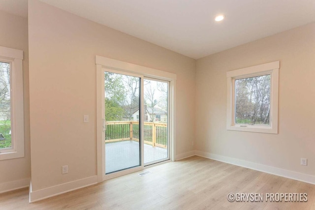 empty room with light hardwood / wood-style floors