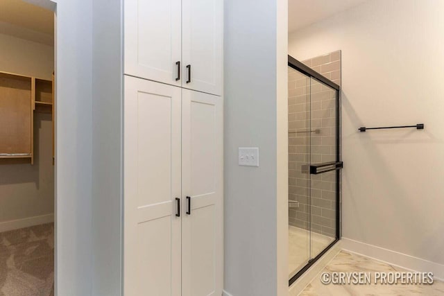 bathroom with a shower with shower door