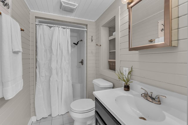 bathroom with tile patterned flooring, vanity, toilet, and walk in shower