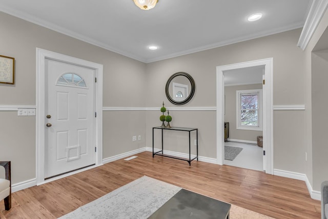 foyer featuring hardwood / wood-style flooring and ornamental molding