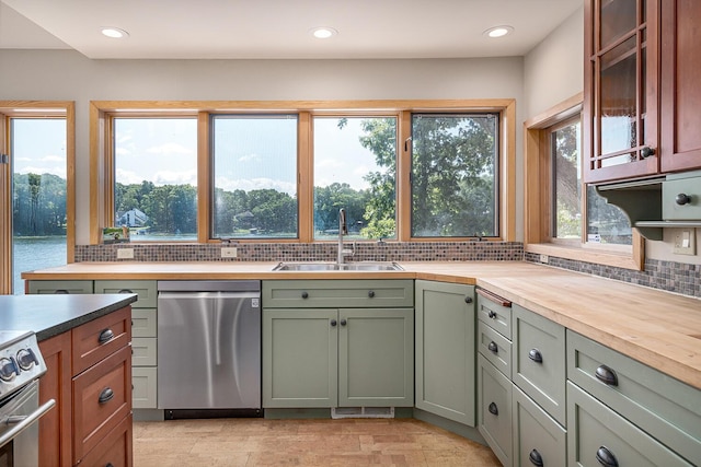 kitchen featuring backsplash, stainless steel appliances, a wealth of natural light, and sink