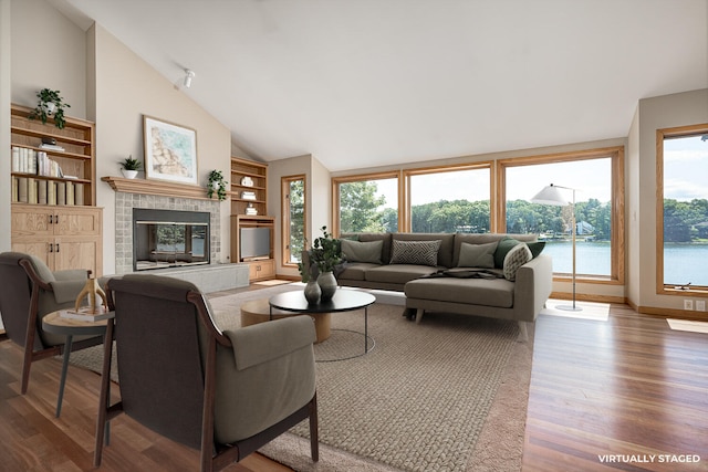 living room featuring a fireplace, wood-type flooring, and high vaulted ceiling