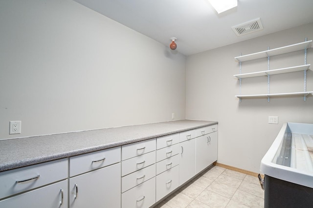 washroom with light tile patterned floors