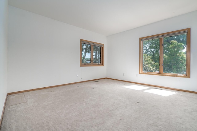 unfurnished room with plenty of natural light and carpet floors