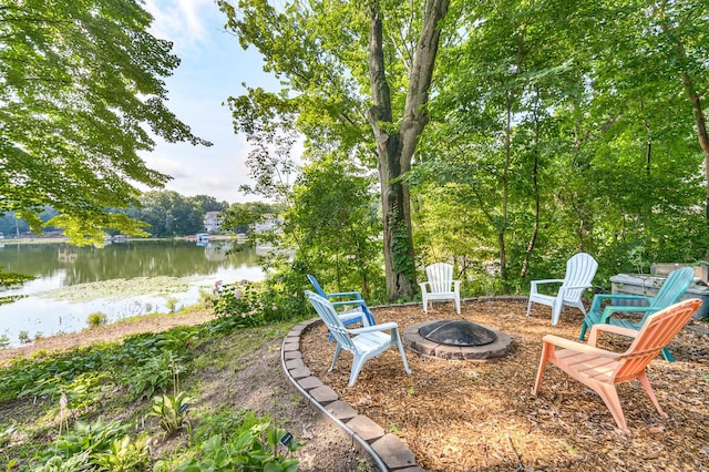 view of patio / terrace with a fire pit and a water view