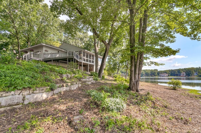 view of yard featuring a deck with water view