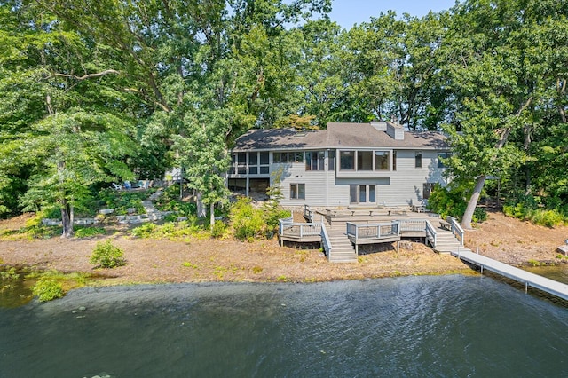 back of house with a deck with water view