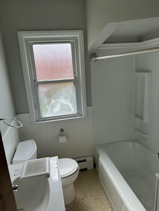 bathroom with tile patterned flooring, a baseboard radiator, tile walls, and toilet